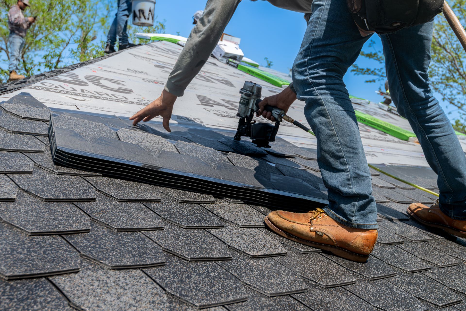 Apex roofing crew installing architectural shingles on a home